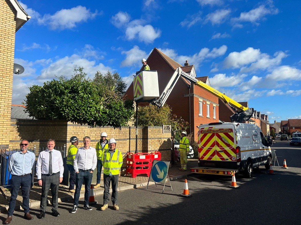 Andrew Allberry, Richard Webster, Paul West and Paul Game stand in a street where an LED streetlight is being installed